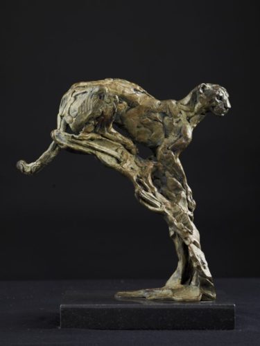 Cheetah on a termite mound sculpture