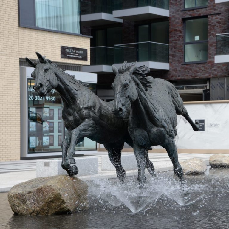 sculpture of two horses running