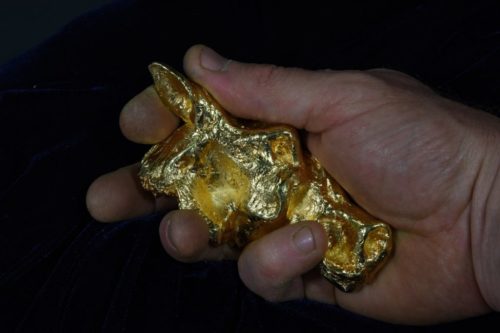 Primitive horse head sculpture in gold