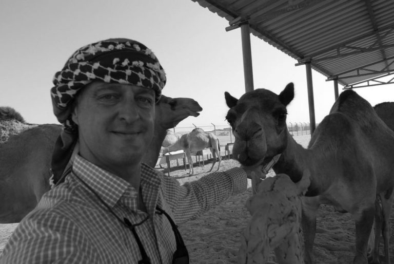 Hamish in the UAE with a camel