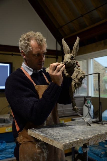 Hamish making hare head sculpture