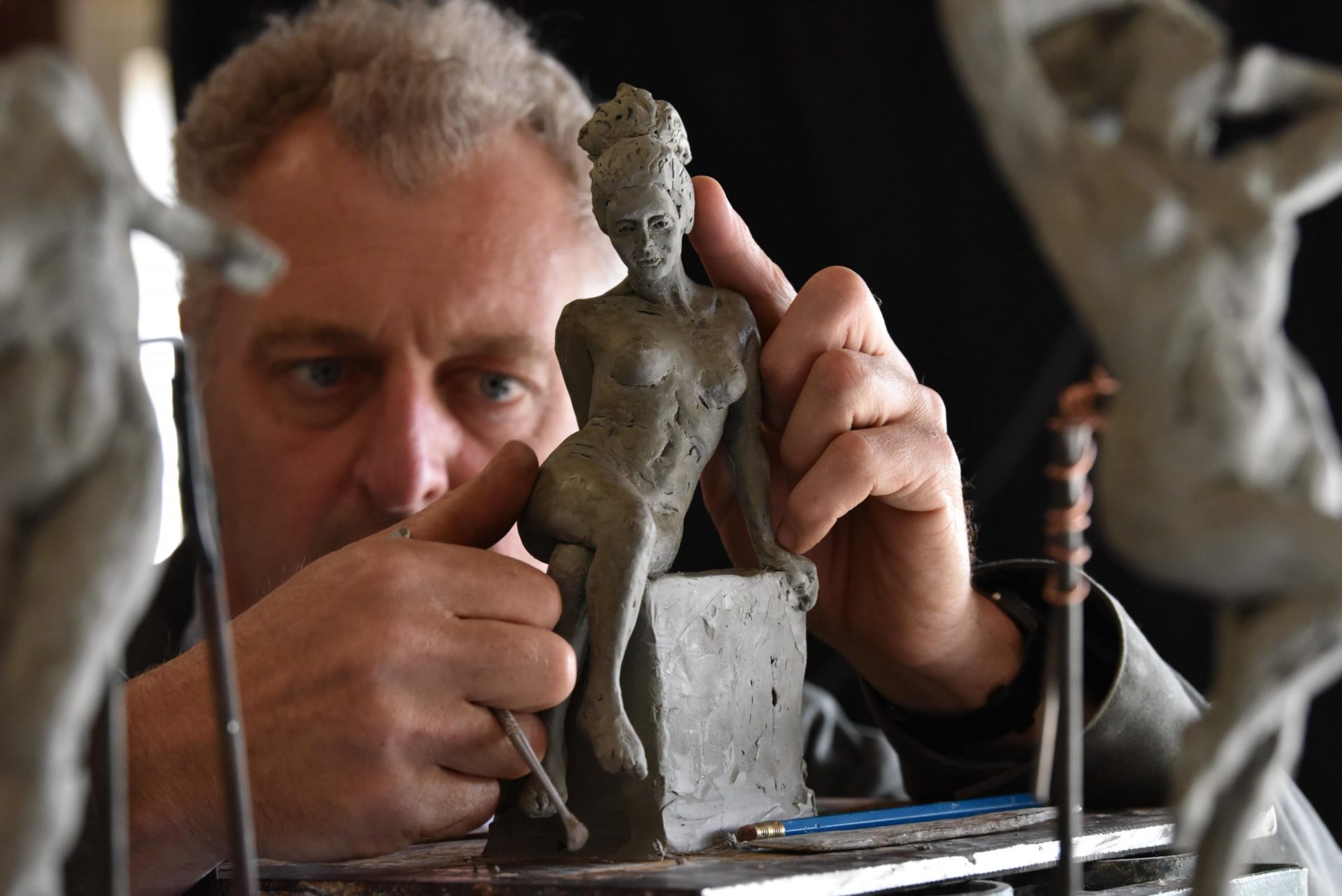 Hamish working on clay model of figurative sculpture