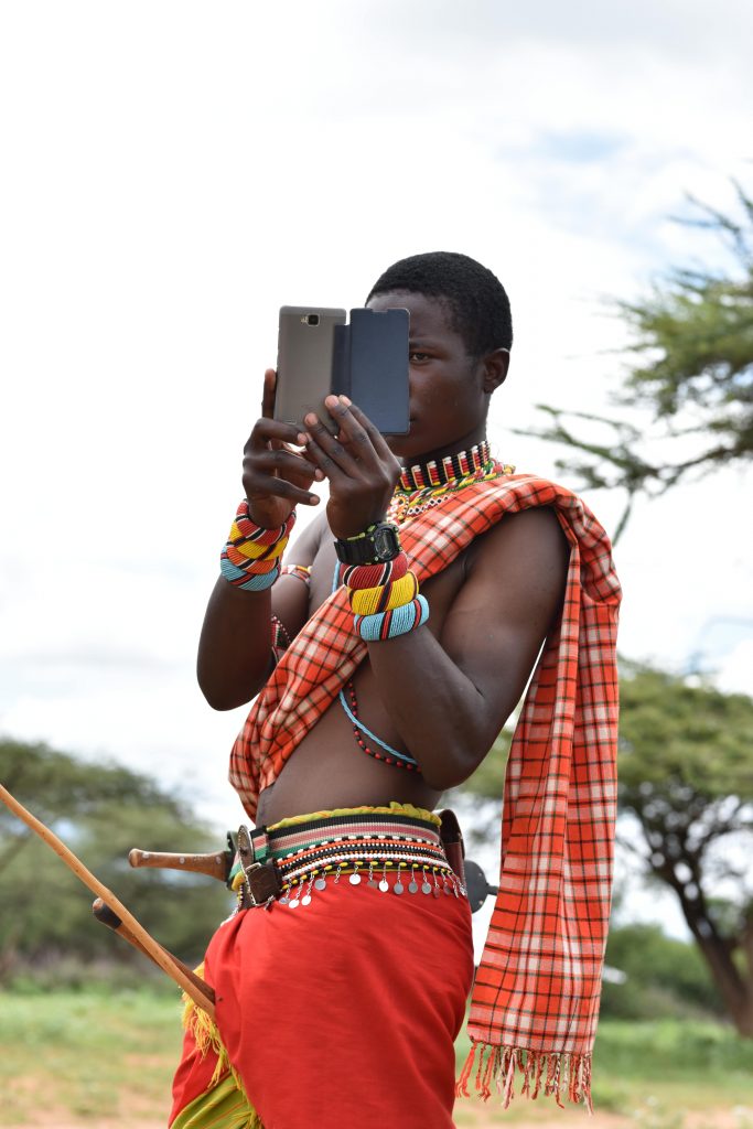Masai warrior with his phone taking photos