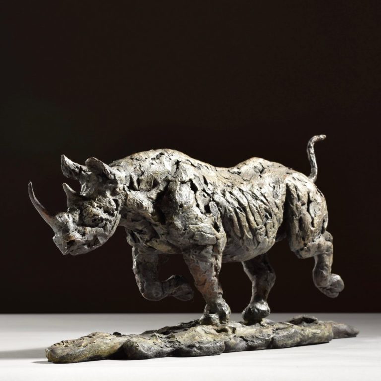 sculpture of black rhino running