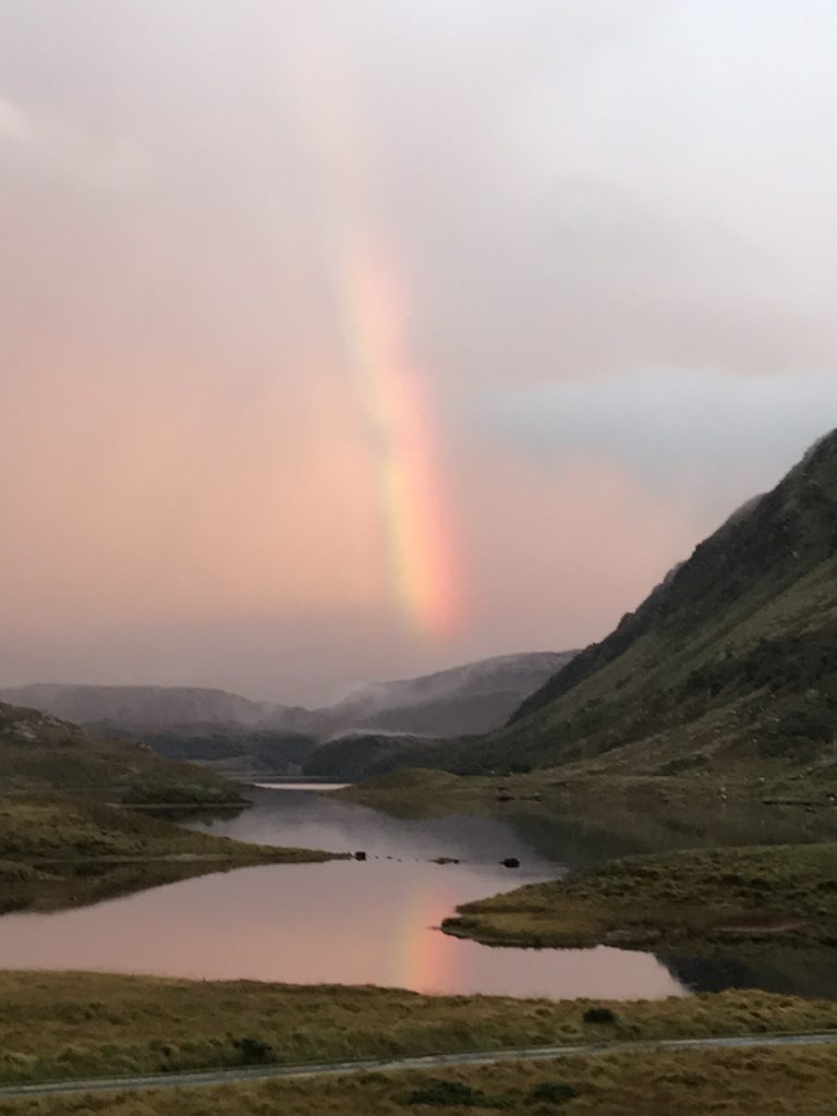 rainbow over loch in Scotland