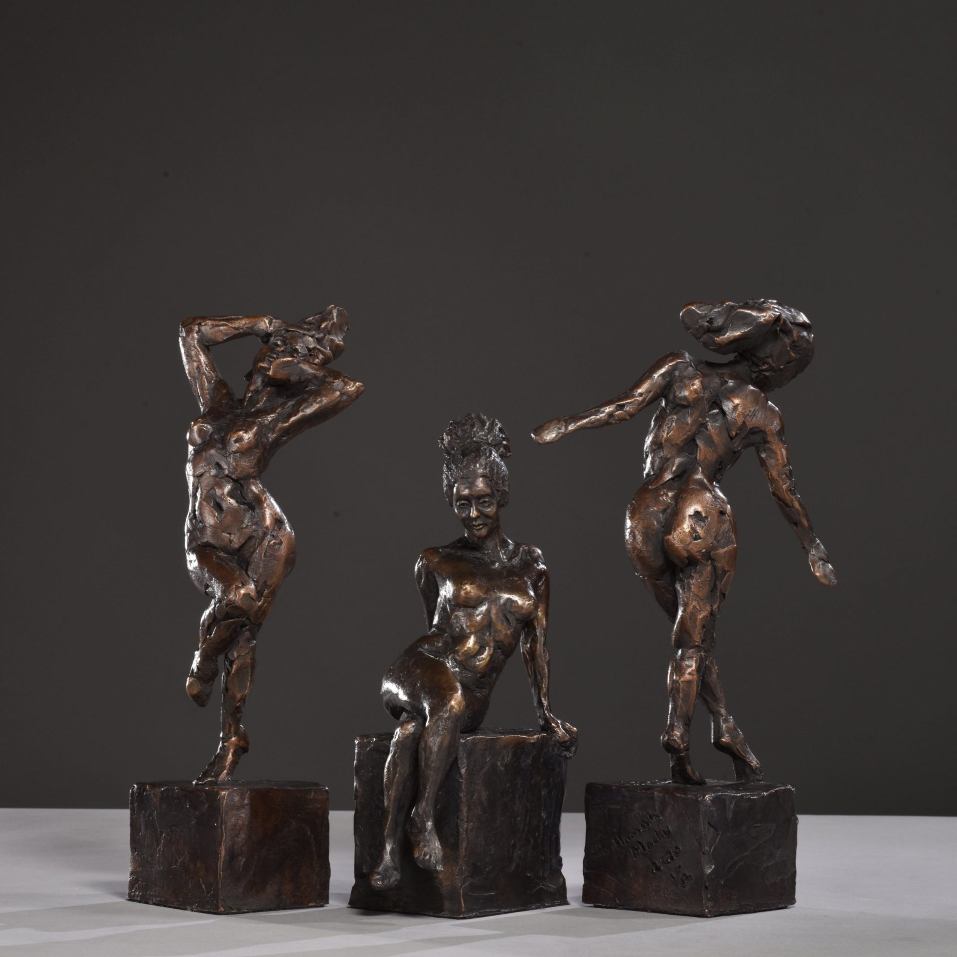 trio of figurative sculptures