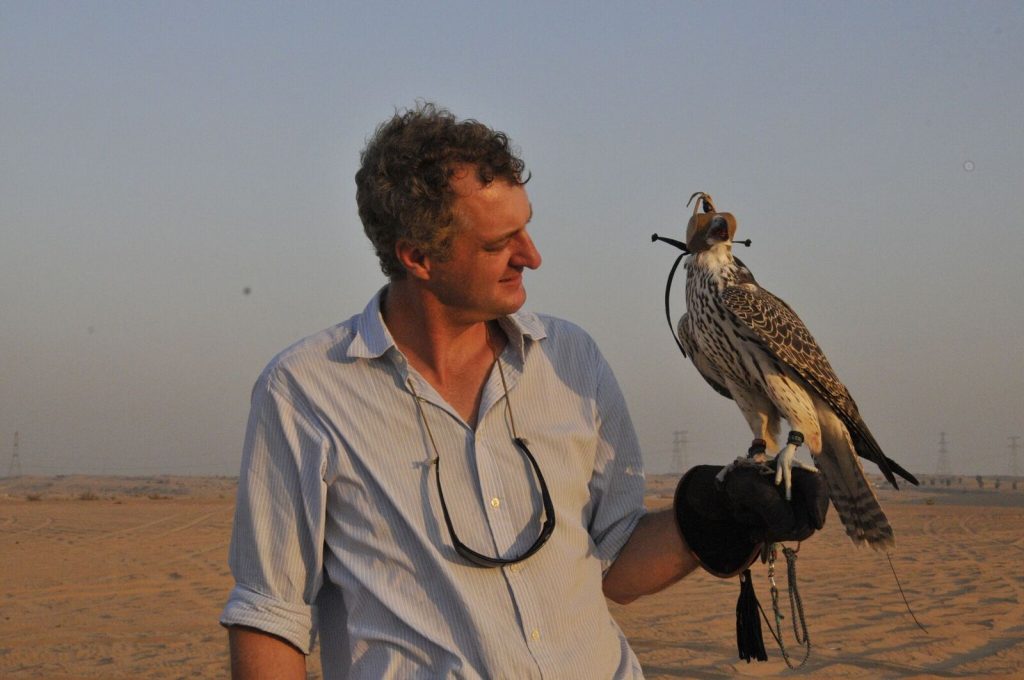 Hamish with falcon in United Arab Emirates