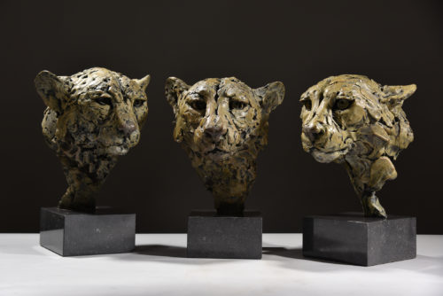 trio of cheetah head sculptures