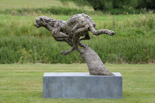 bronze cheetah sculpture displayed outdoors