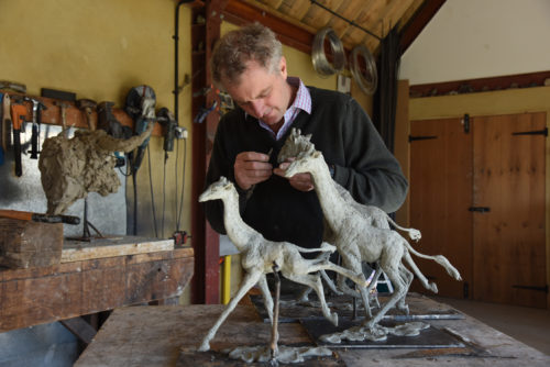 Hamish with models of giraffe sculpture