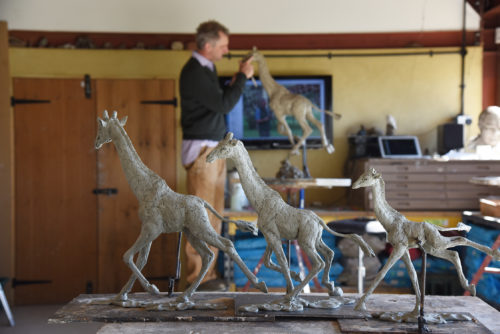 clay models of giraffe sculpture in workshop