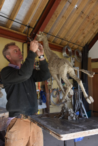 Hamish making giraffe sculpture