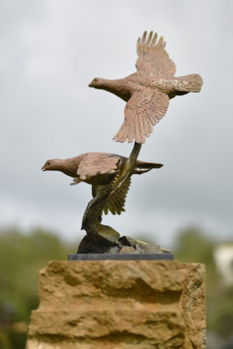 bronze sculpture of two grouse