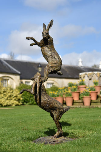 hares boxing sculpture in garden