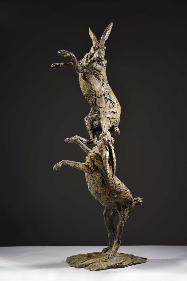 sculpture of hares boxing
