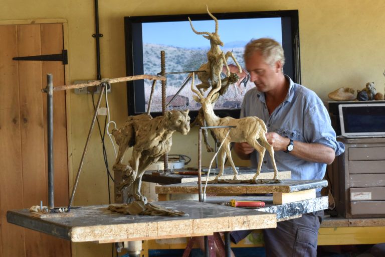 Hamish in workshop with impala sculpture and others