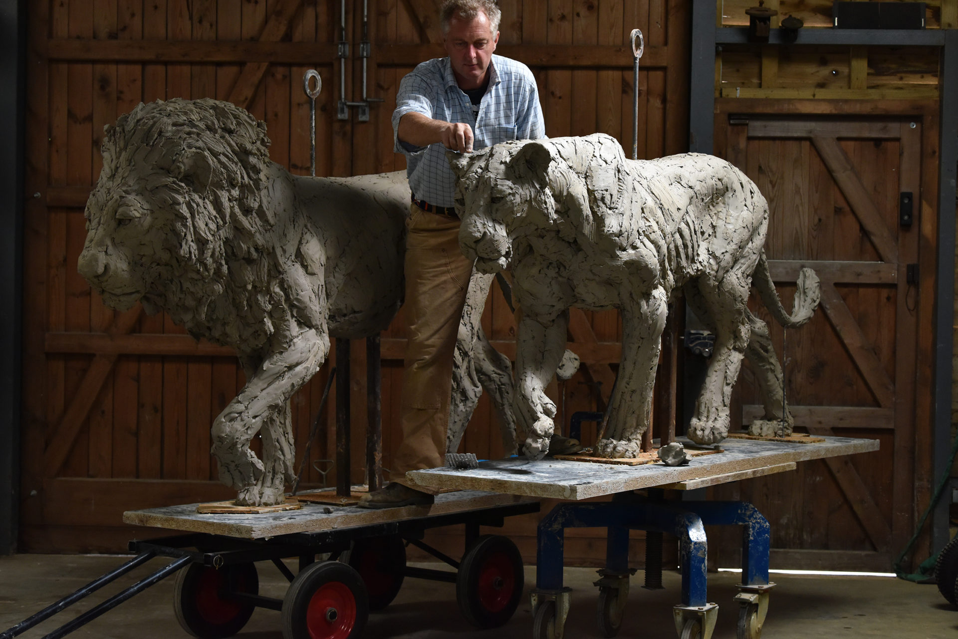 Hamish making lion sculptures