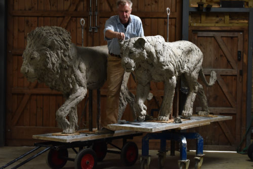 Hamish making lion sculptures