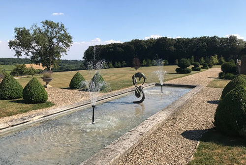 bronze otters sculpture by pool