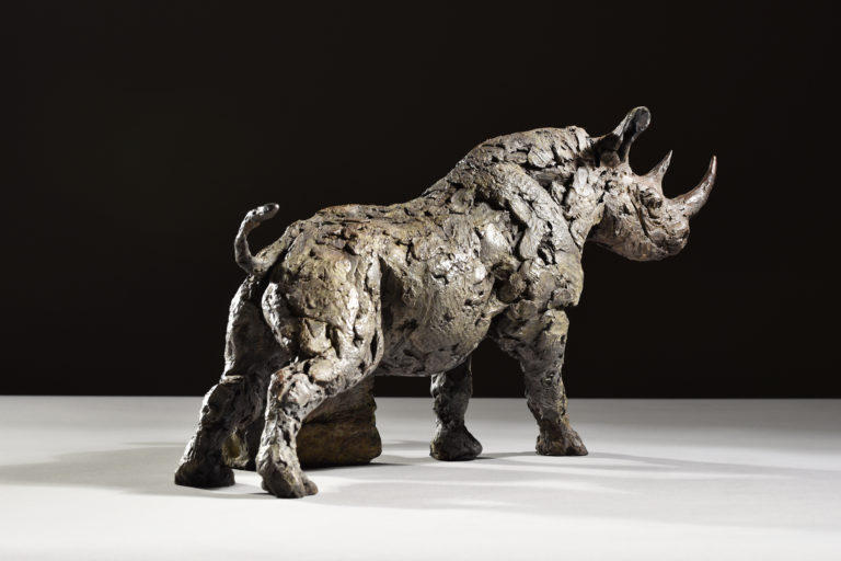 sculpture of black rhino scratching
