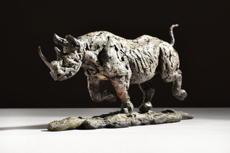 bronze sculpture of black rhino running