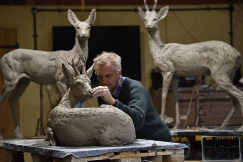 Hamish making roe buck sculptures