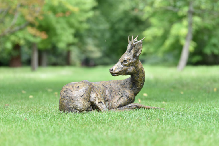 sculpture of roe buck lying down