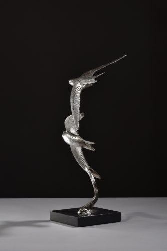 silver sculpture of swifts