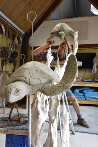 Hamish making turtles sculpture