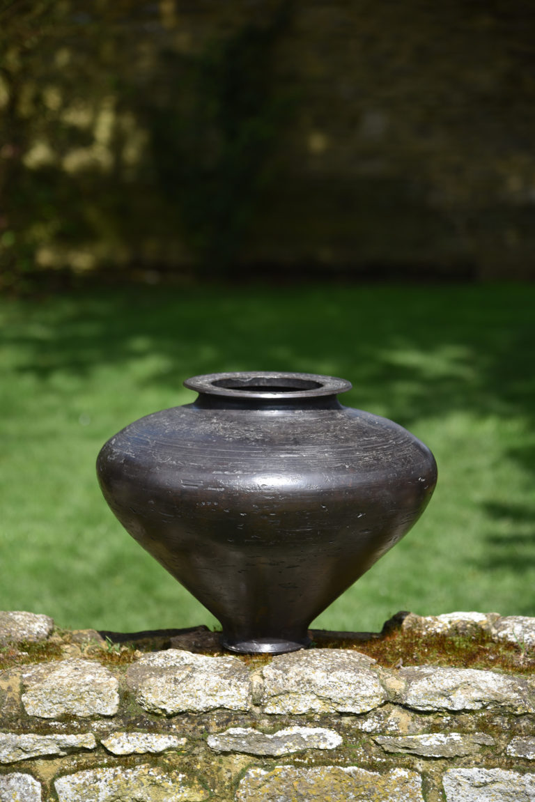 bronze vessel on top of a wall