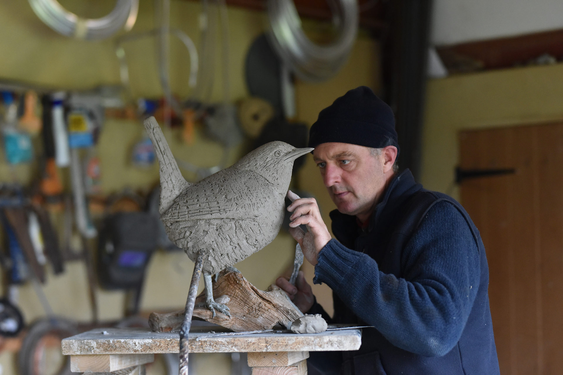 working on large bronze wren sculpture