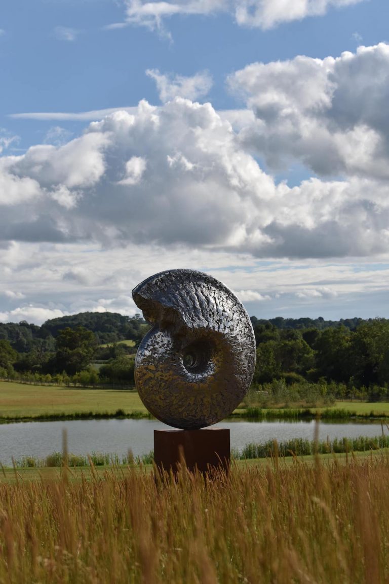 Hamish Mackie's ammonite sculpture beside a lake