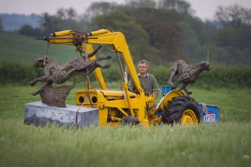 Hamish moving cheetah sculptures with a tractor