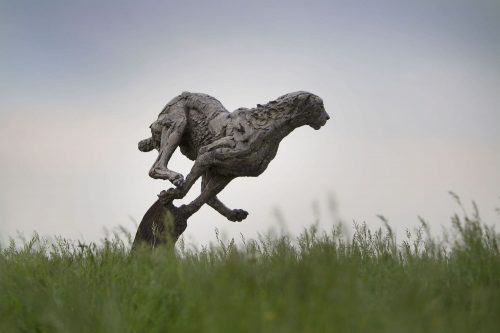 sculpture of cheetah in field