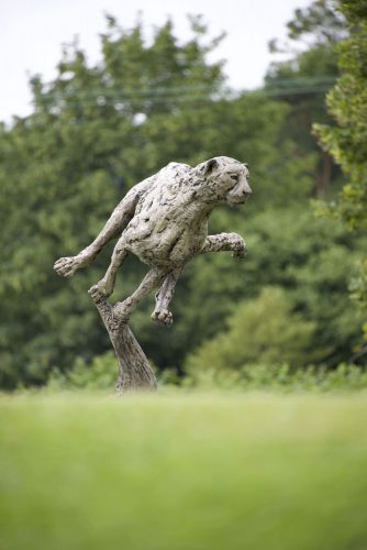 cheetah sculpture in a field