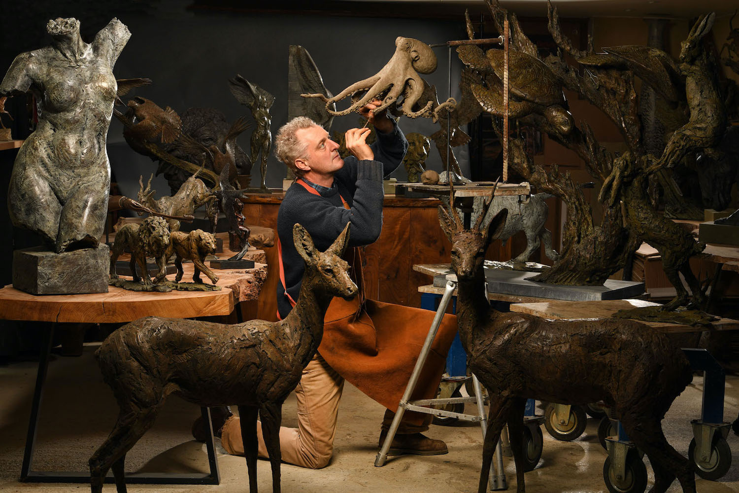 Hamish Mackie in studio surrounded by sculptures