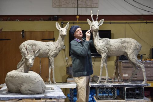 Hamish with two sculptures of deer