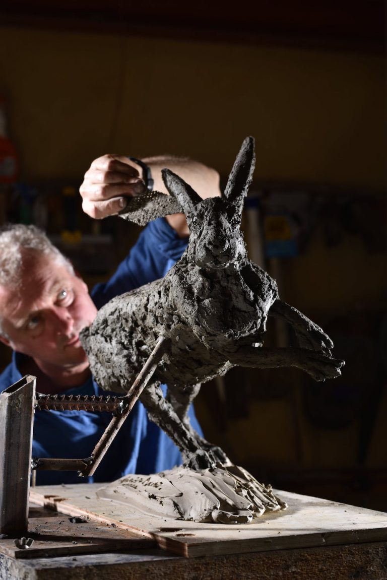 Hamish making hare running sculpture