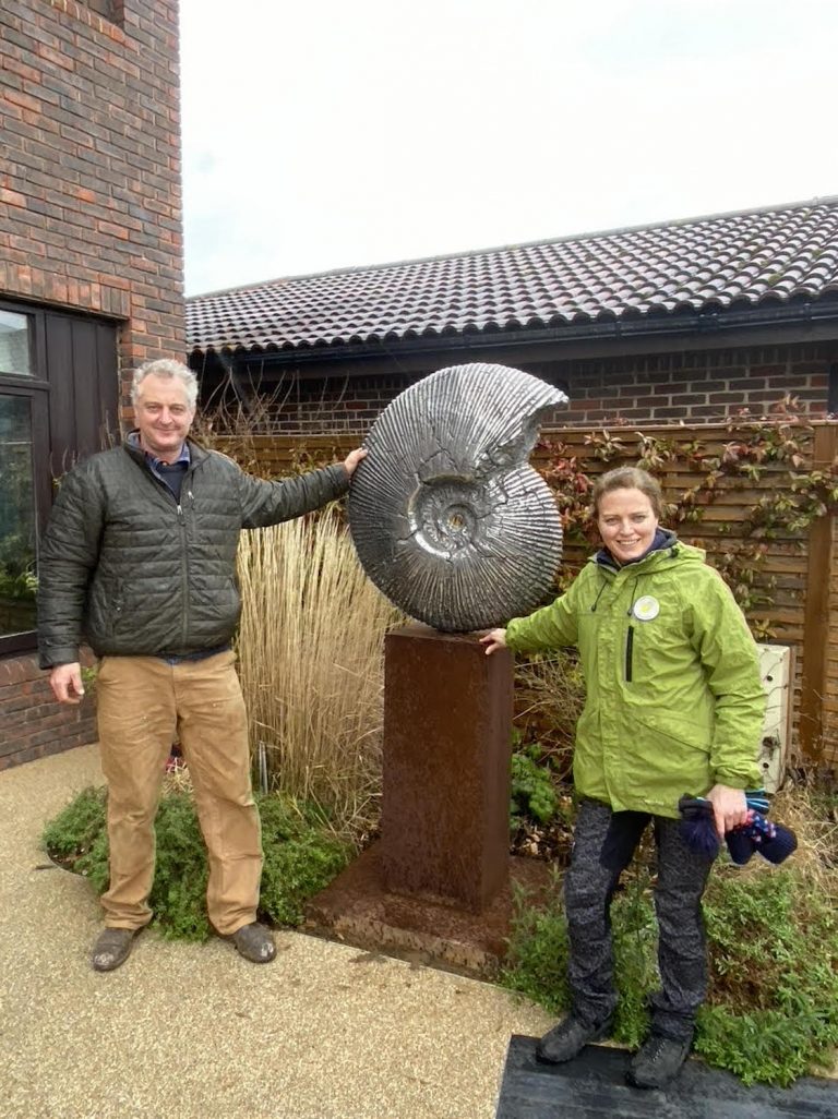 Hamish and Amy Moffett in garden with sculpture