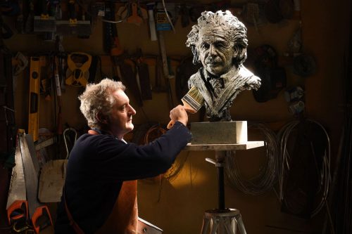 Hamish Mackie brushing Einstein sculpture