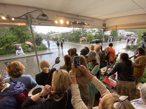 crowds shelter from the rain at Chelsea