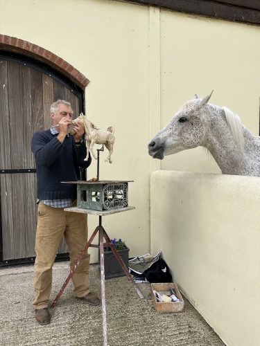 Hamish making Arabian horse sculpture