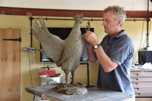 Hamish making pheasant sculpture