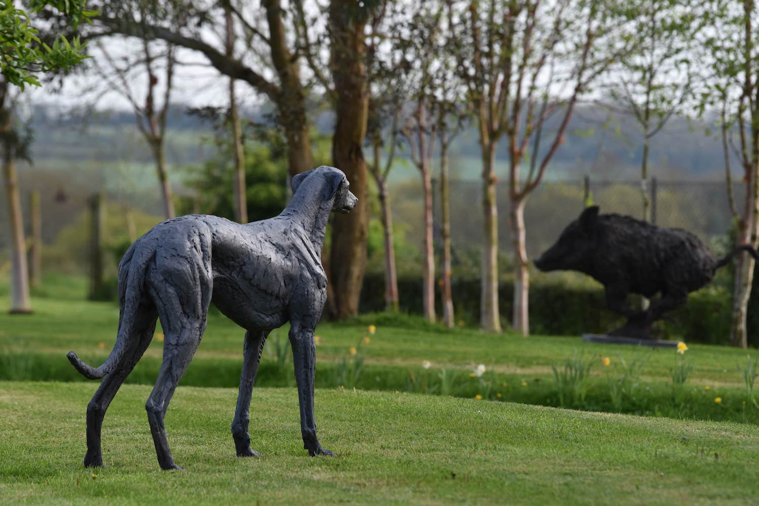 Garden with bronze sculpture of greyhound