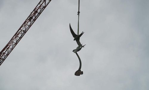 swift sculpture in sky on crane