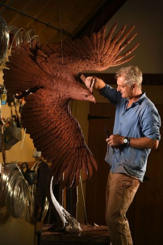 Hamish making bald eagle sculpture