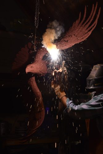 Hamish making bald eagle clay sculpture