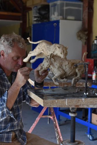 Hamish in studio sculpting warthog sculpture