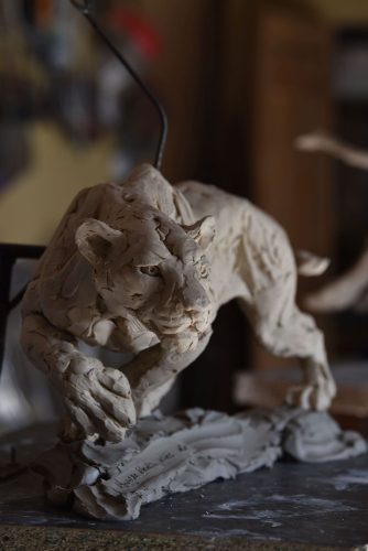 Stalking lioness in clay