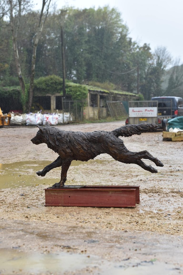 Running wolf sculpture